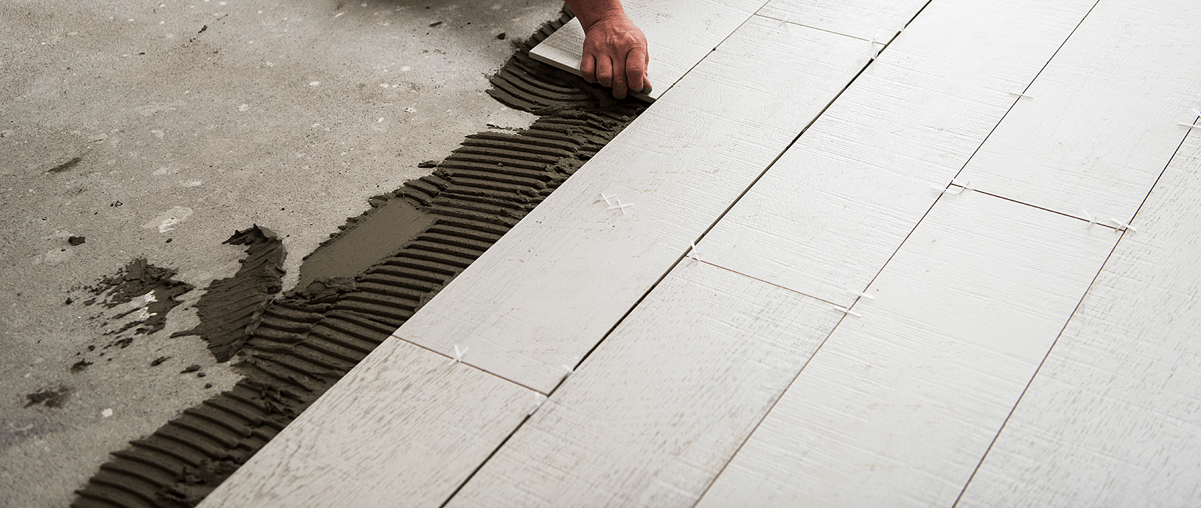 worker installing floor hero